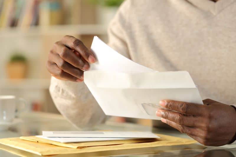 man opening rent check